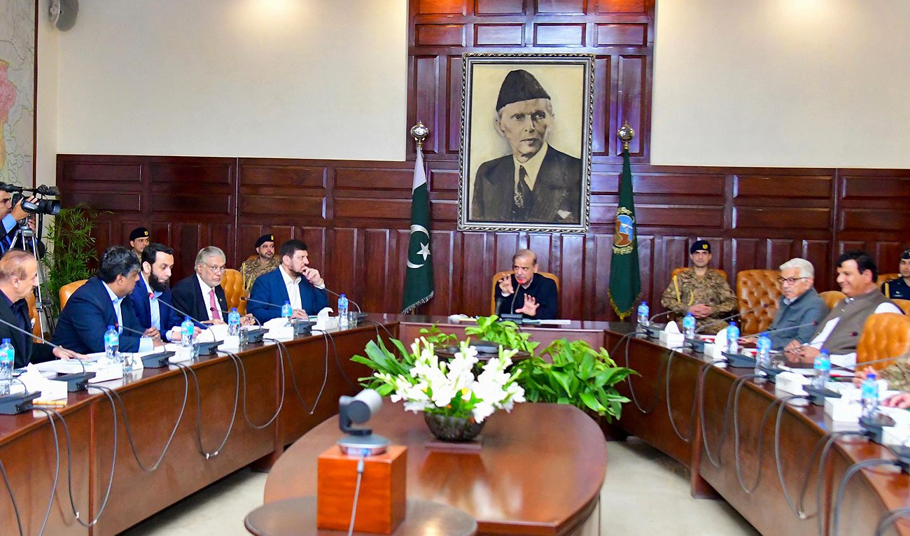 In this handout photo, taken and released by Prime Minister Office, Pakistan Prime Minister Shehbaz Sharif chairs meeting to monitor the rain and flood situation in Khyber Pakhtunkhwa province at the Governor House in Peshawar on March 6, 2024. (Photo courtesy: PMO)