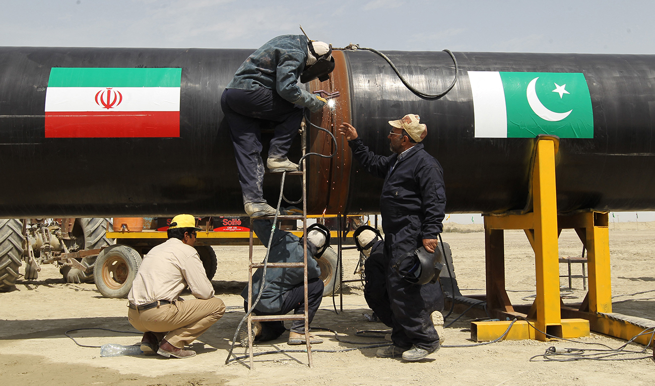 Irani workers work on a section of a pipeline on March 11, 2013 at the Iranian border city of Chah Bahar. (AFP/File)
