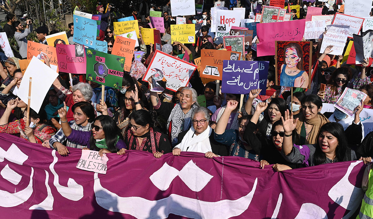 Women hold placards and shout slogans during a march on the occasion of International Women’s Day in Lahore on March 8, 2024. (AFP)