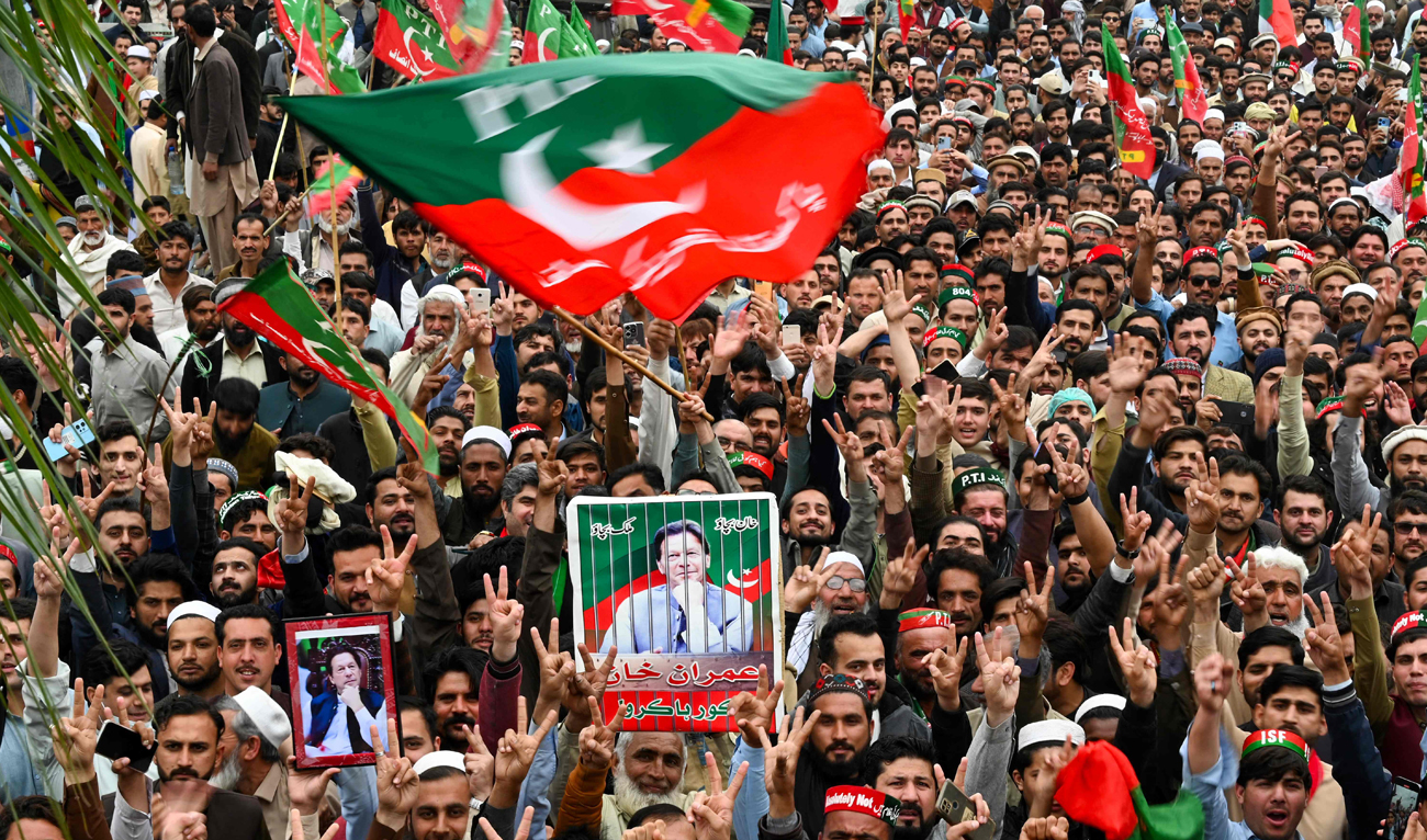 Pakistan Tehreek-e-Insaf (PTI) party supporters hold portraits of Pakistan's former prime minister Imran Khan, as they protest against the alleged skewing in Pakistan's national election, in Peshawar on March 10, 2024. Pakistan's election commission blocked lawmakers loyal to jailed ex-prime minister Imran Khan from taking a share of parliamentary seats reserved for women and minorities, after a poll marred by rigging claims. (AFP)