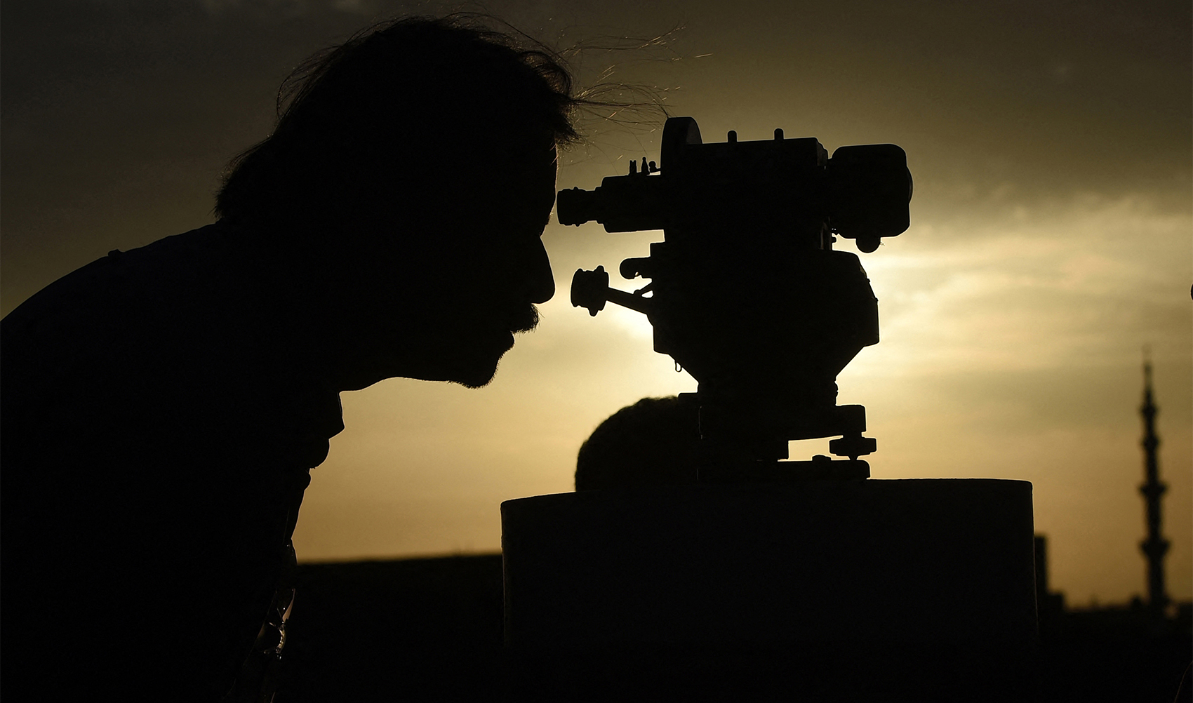 A member of Pakistan's Ramadan moon-sighting committee uses a telescope to observe the appearance of the Ramadan Moon in Karachi on March 22, 2023, to mark the beginning of the holy month of Ramadan. (AFP/File)