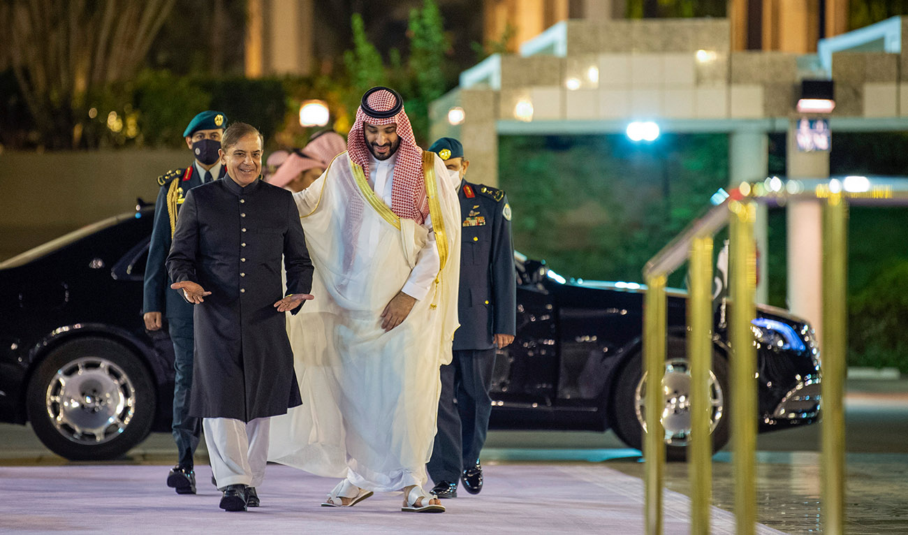 A handout picture provided by the Saudi Royal Palace shows Saudi Arabia's Crown Prince Mohammed Bin Salman (R) welcoming Pakistani Prime Minister Shehbaz Sharif in Jeddah on April 30, 2022. (AFP/File)