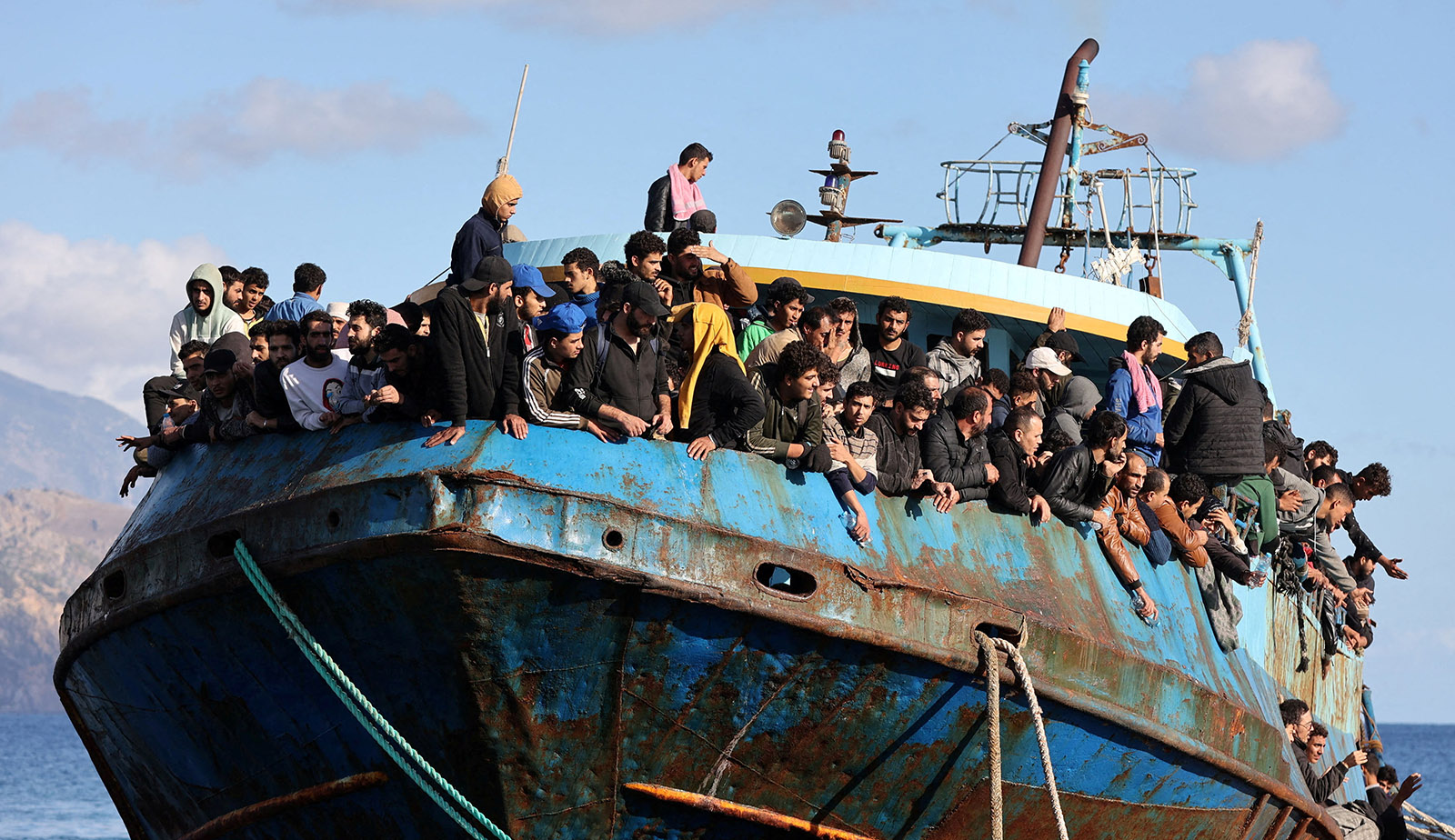 Migrants sit onboard a fishing boat at the port of Paleochora, following a rescue operation off the island of Crete, Greece, November 22, 2022. (Reuters/ File)