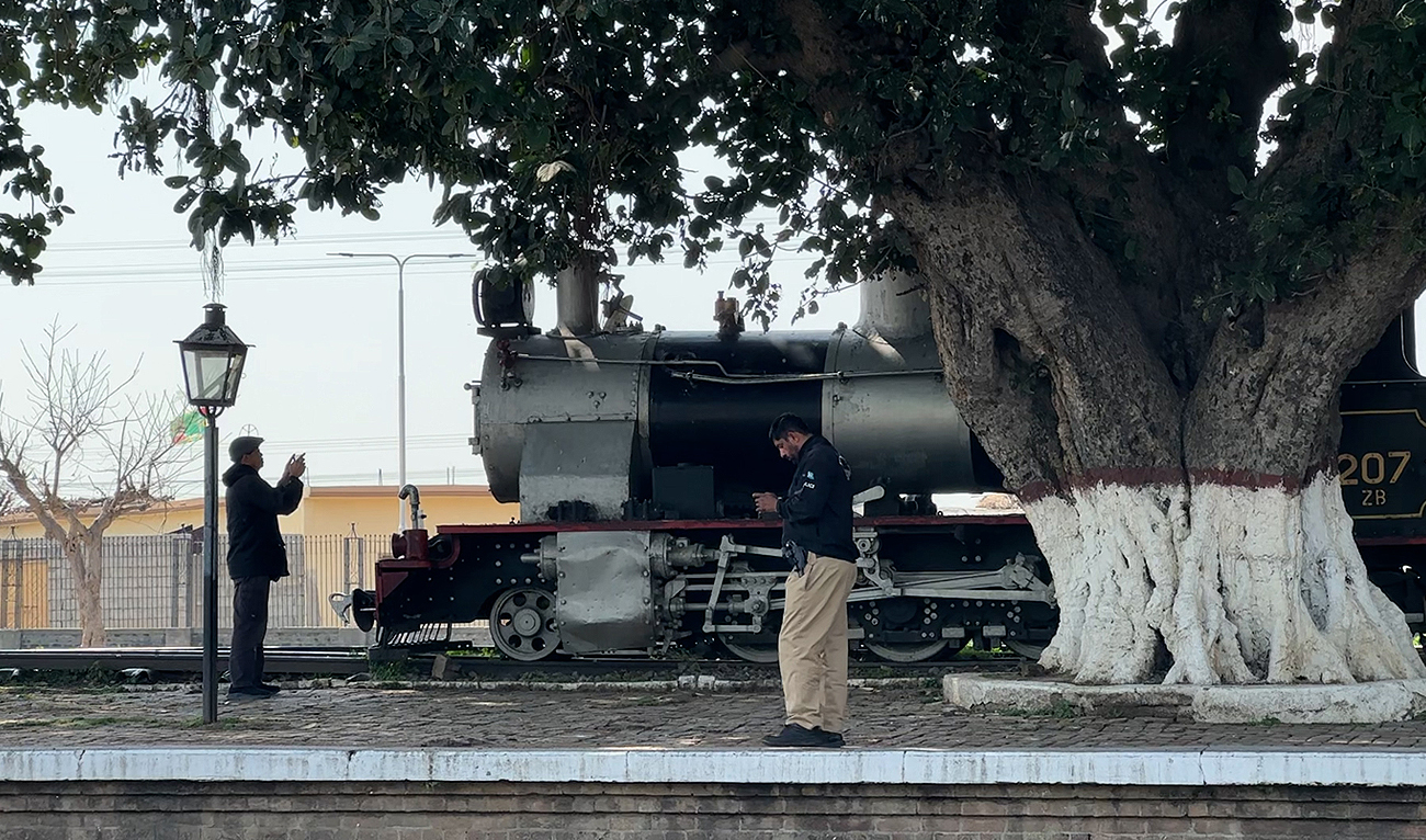 A visitor photographs an 1826 steam locomotive Rx 207 on display at Pakistan Railways Heritage Point in Golra Sharif railway station on the outskirts of Islamabad on March 6, 2024. (AN Photo)