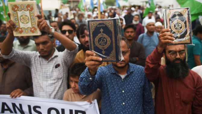 In this file photo, taken on July 5, 2023, supporters of Pakistan’s Jamaat-e-Islami party hold copies of the Qur’an during a demonstration in Karachi against Qur’an burning. (AFP/File)