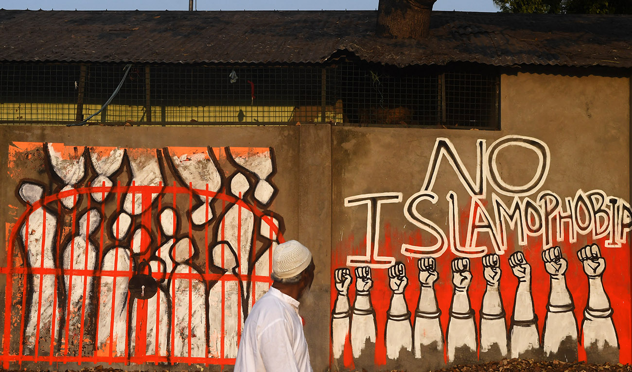 A man walks past a wall reading 'No Islamophobia' as a sign of protest against India's new citizenship law, in Kolkata on February 14, 2020. (AFP/File)