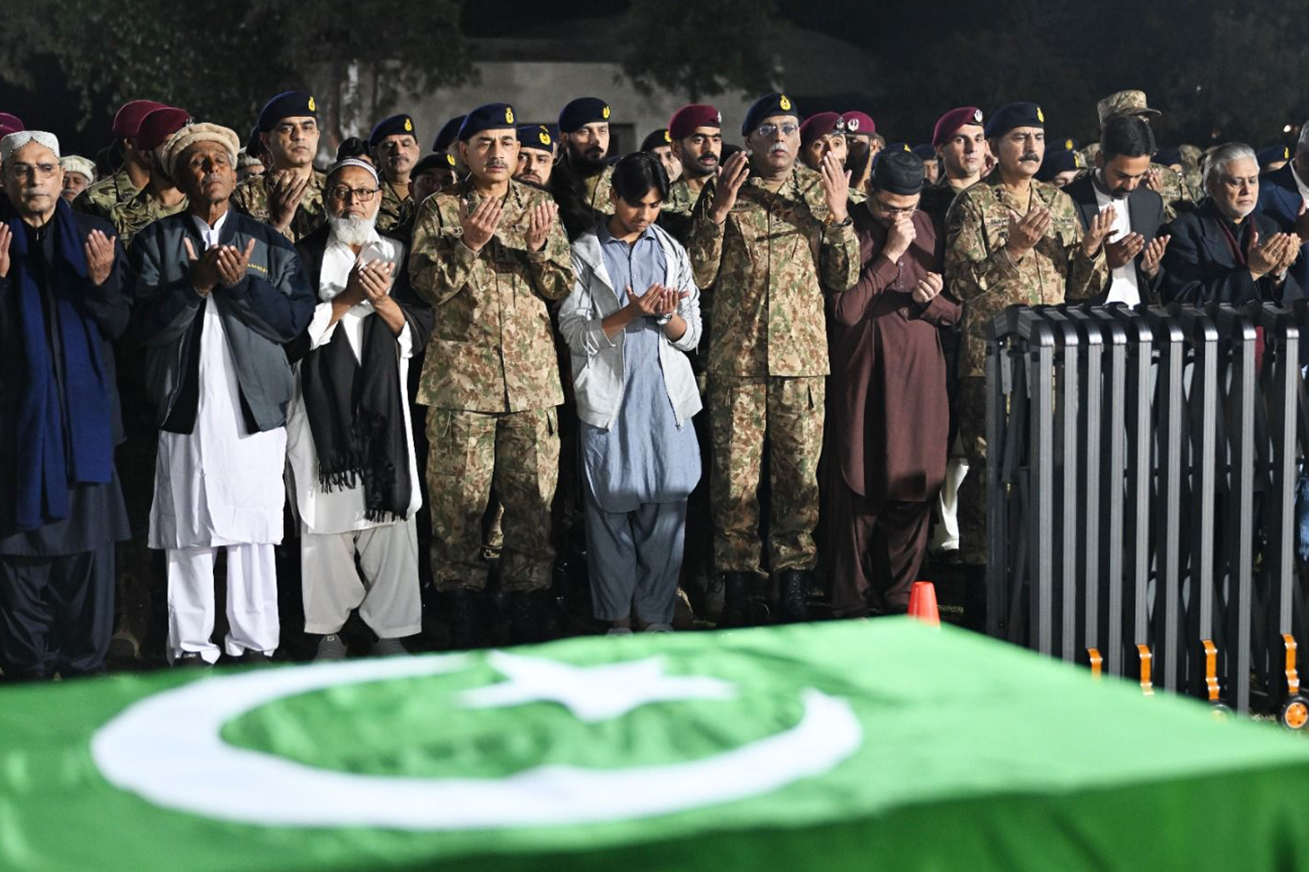 In this handout photo, taken and released by Pakistan’s Inter-Service Public Relations (ISPR), President of Pakistan Asif Ali Zardari (1L), Chief of Army Staff of Pakistan Asim Munir (4L), and General Sahir Shamshad Mirza (6L), Chairman Joint Chief of Staff Committee, along with others attend the funeral prayers of two army officers, who were killed during a militant attack on a military post in Mir Ali area of North Waziristan district early Saturday, at Chaklala Garrison in Rawalpindi on March 17, 2024. (Photo courtesy: ISPR)
