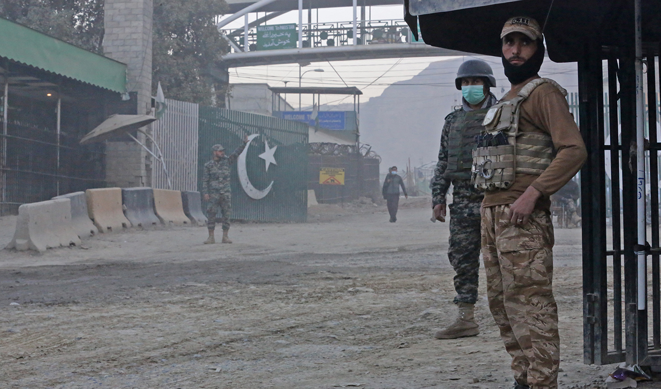 Afghan security personnel (R) and Pakistani border policemen stand guard at the zero point Torkham border crossing between Afghanistan and Pakistan, in Nangarhar province on December 6, 2023. (AFP/File)
