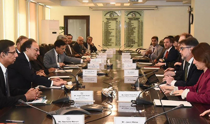 In this handout photograph released by Pakistan’s Press Information Department (PID) and taken on March 14, 2024, Pakistan’s Finance Minister Muhammad Aurangzeb (2L) speaks with International Monetary Fund (IMF) Mission Chief for Pakistan Nathan Porter (2R) during a meeting in Islamabad. (PID/File)