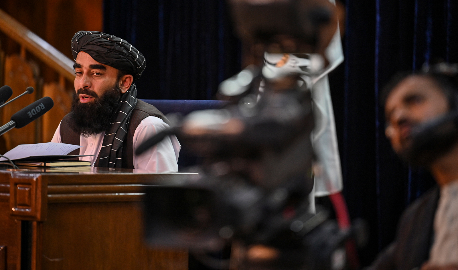 Taliban spokesman Zabiullah Mujahid (L) addresses a press conference at government media and information center in Kabul city, on October 30, 2021. (AFP/File)