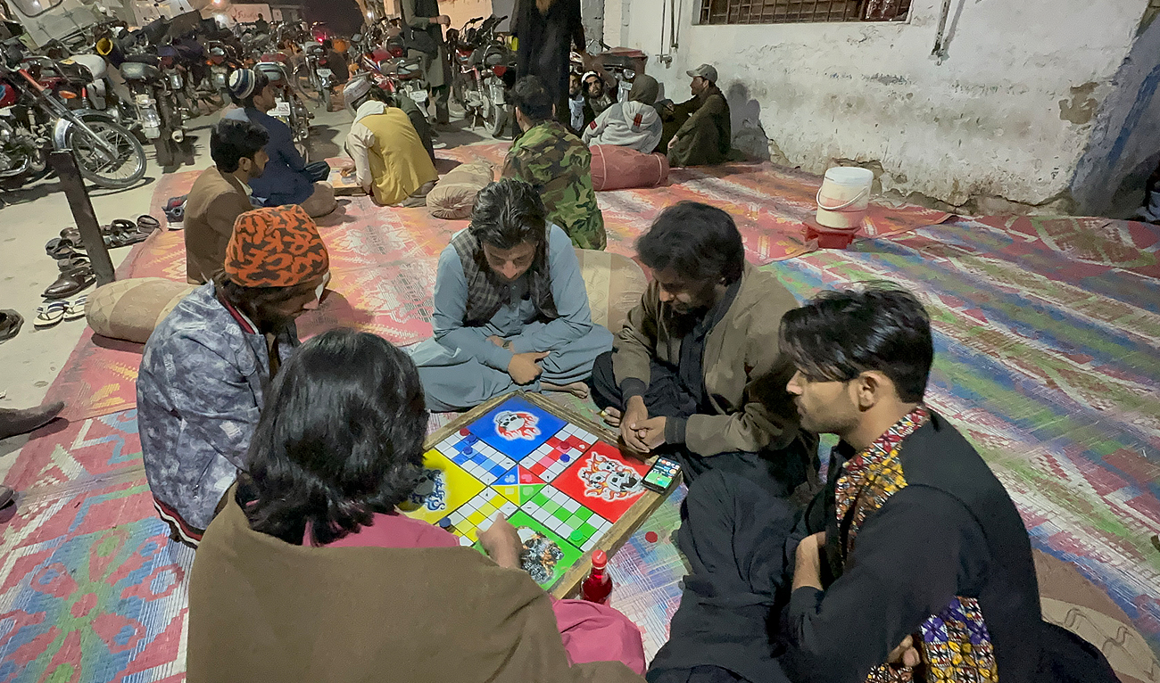 Local residents play Lodu at a famous cafe in Quetta Pakistan on March 19, 2024. (AN Photo)