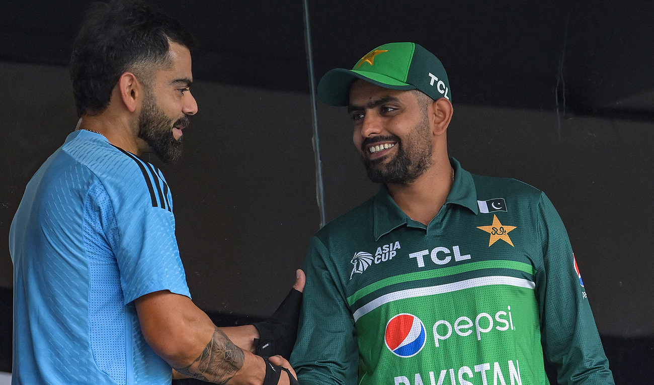 In this file photo, taken on September 2, 2023, India’s Virat Kohli (L) shakes hands with Pakistan’s captain Babar Azam before the start of the Asia Cup 2023 one-day international (ODI) cricket match between India and Pakistan at the Pallekele International Cricket Stadium in Kandy. (AFP/File)
