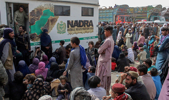 Afghan refugees gather in front of the National Database and Registration Authority (NADRA) vans for biometric verification before their departure to Afghanistan, at a holding centre near Pakistan-Afghanistan border in Chaman on November 1, 2023. (AFP/File)