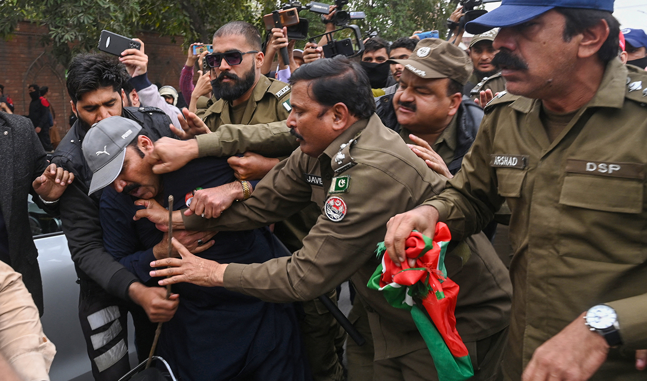 Police detain a supporter of former prime minister Imran Khan's Pakistan Tehreek-e-Insaf (PTI) party, at a protest against the alleged skewing in Pakistan's national election, in Lahore on March 10, 2024. (AFP/File)