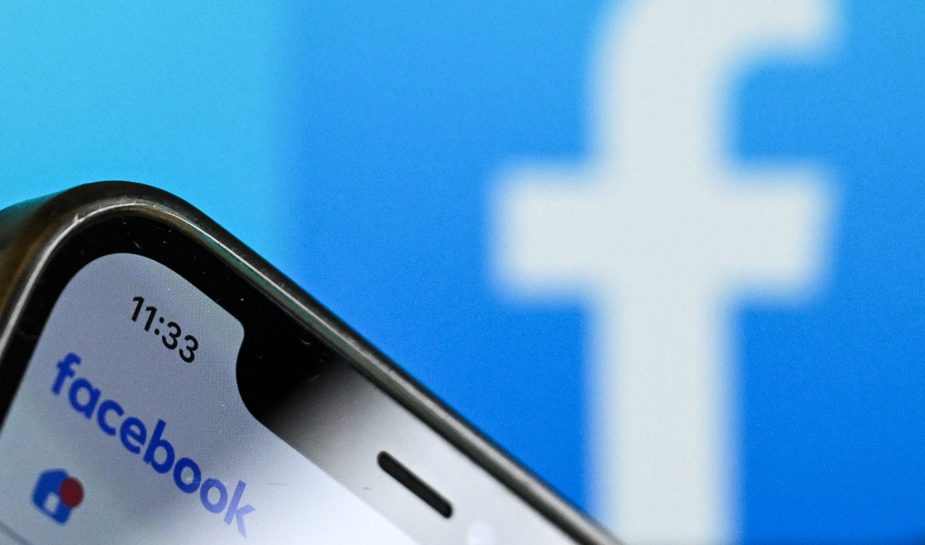 A photo taken on November 17, 2023 shows the logo of US online social media and social networking service Facebook on a smartphone screen in Frankfurt am Main, western Germany. (AFP/File)