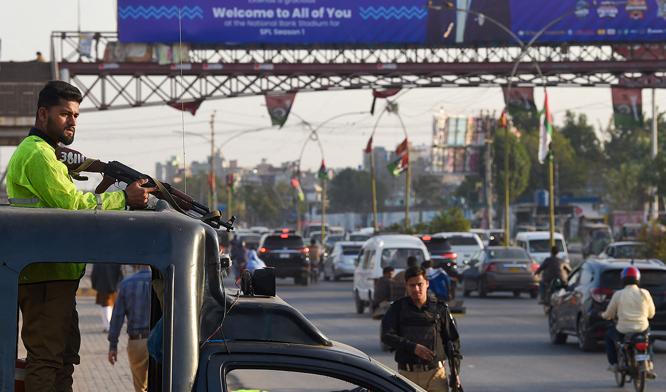 Policemen stand guard along a street in Karachi on February 1, 2024. (AFP/File)