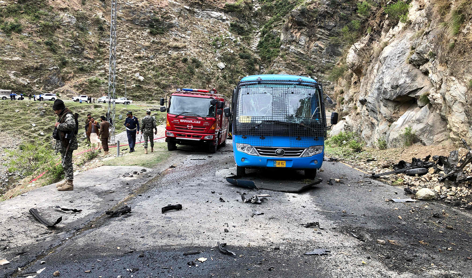 Security personnel inspect the site of a suicide attack near Besham city in the Shangla district of Khyber Pakhtunkhwa province on March 26, 2024. (AFP)