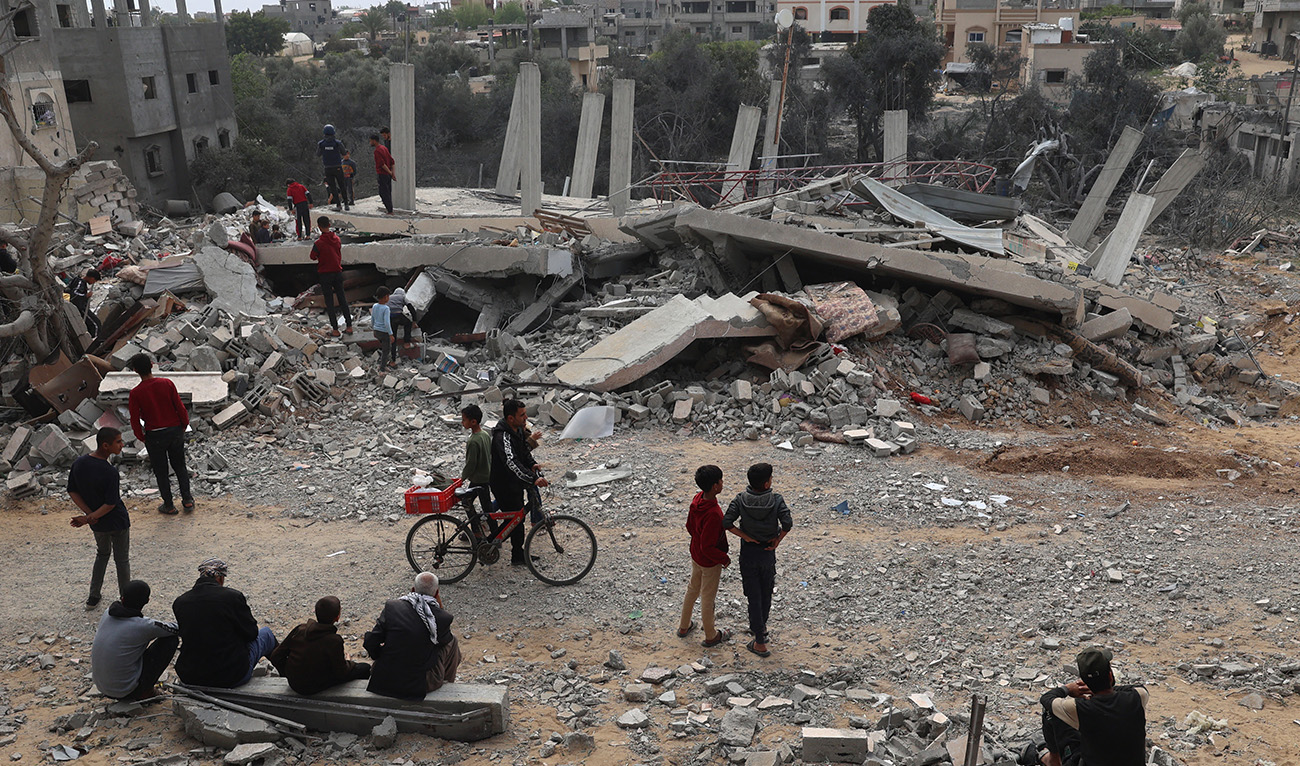 Palestinians inspect the damage to a building after overnight Israeli bombardment in Rafah in the southern Gaza Strip on March 29, 2024. (AFP)