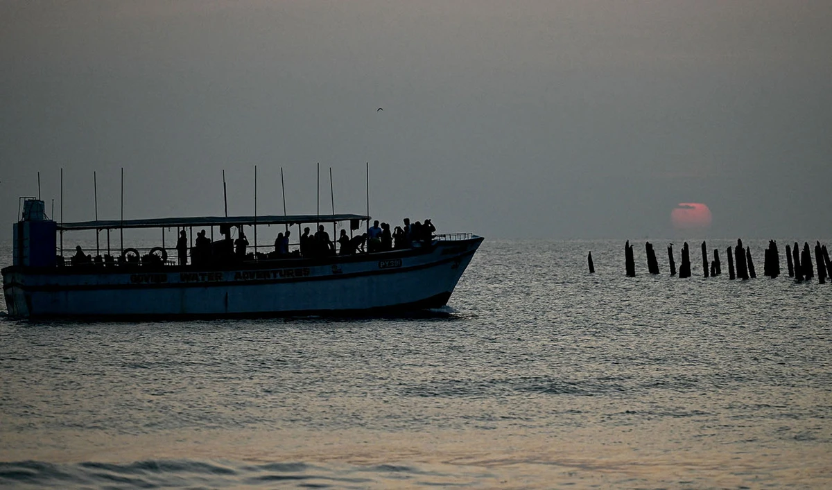 A tourist boat makes its way in the Bay of Bengal as the sun rises in Puducherry on January 17, 2024. (AFP/File)