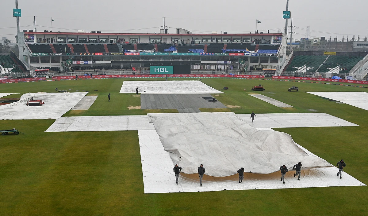 Ground staff covers the pitch as it rains and delays the start of the Pakistan Super League (PSL) Twenty20 cricket match between Peshawar Zalmi and Lahore Qalandars in the Rawalpindi Cricket stadium in Rawalpindi on March 2, 2024. (AFP)
