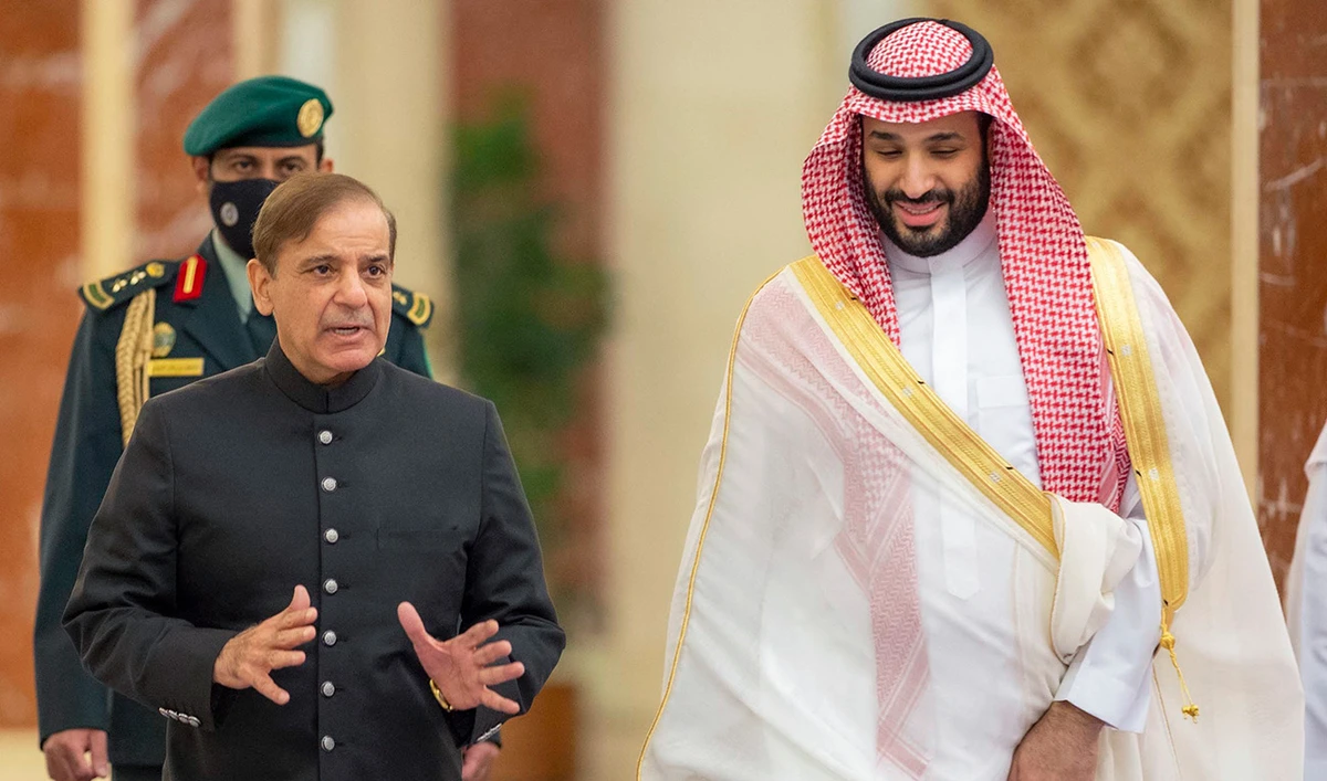 A handout picture provided by the Saudi Royal Palace shows Saudi Arabia's Crown Prince Mohammed Bin Salman (R) welcoming Pakistani Prime Minister Shehbaz Sharif in Jeddah on April 30, 2022. (AFP/File)