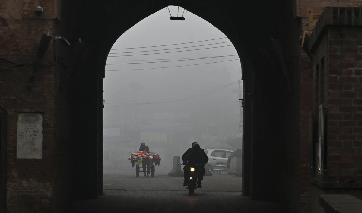 A motorists rides under a gate amid heavy smog conditions in Lahore January 17, 2024. (AFP)