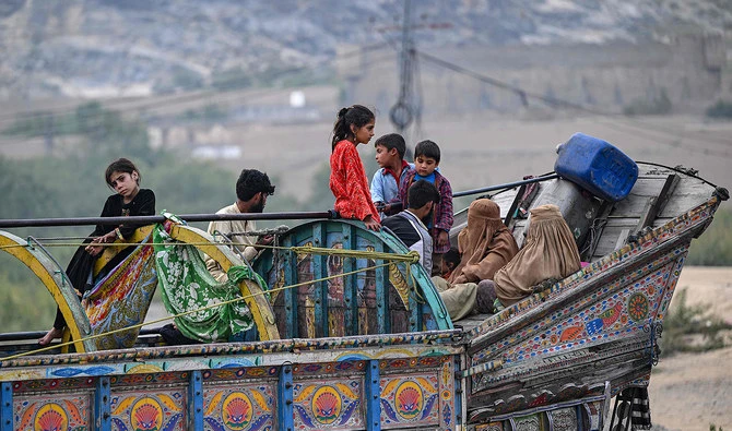 Afghan refugees arrive in a truck at a holding centre as they prepare to depart for Afghanistan, in Landi Kotal on November 1, 2023. (AFP)