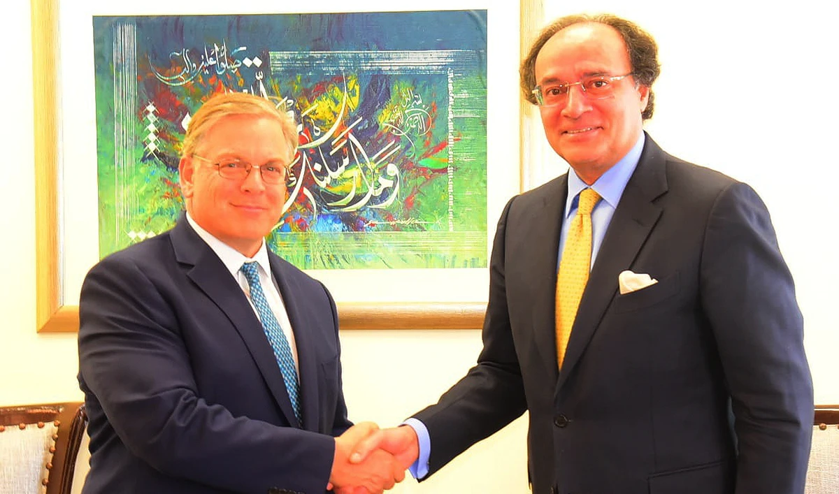 In this handout photo, taken and released by Pakistan’s Finance Ministry, Finance Minister Muhammad Aurangzeb shakes hands with the US Ambassador to Pakistan Donald Blome at the Ministry of Finance in Islamabad on March 19, 2024. (Photo courtesy: Finance Ministry)