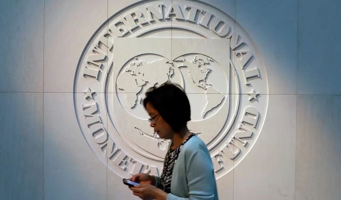A woman walks past the International Monetary Fund (IMF) logo at its headquarters in Washington DC, United States, on May 10, 2018. (REUTERS)