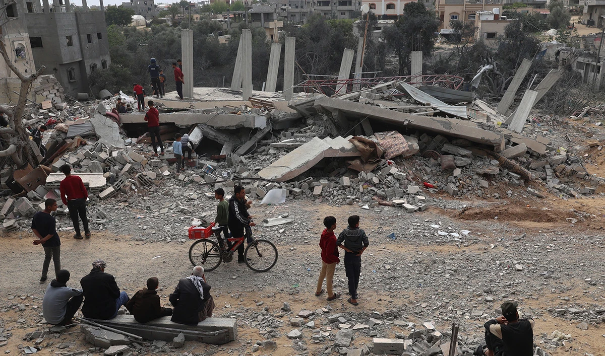 Palestinians inspect the damage to a building after overnight Israeli bombardment in Rafah in the southern Gaza Strip on March 29, 2024. (AFP)