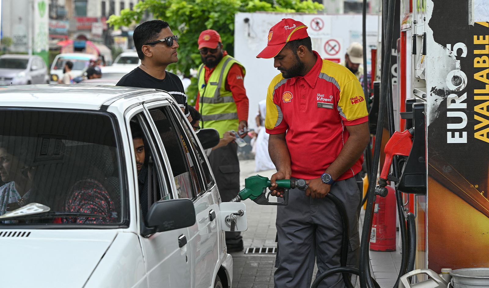A worker pumps petrol in a car at a fuel station in Rawalpindi on July 16, 2023. (AFP/File)