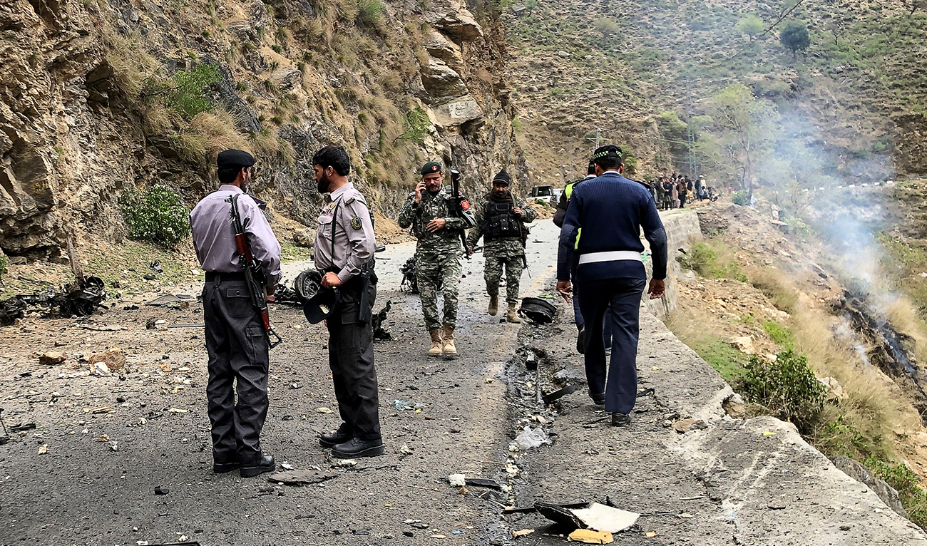 Security personnel inspect the site of a suicide attack near Besham city in the Shangla district of Khyber Pakhtunkhwa province on March 26, 2024. (AFP/File)