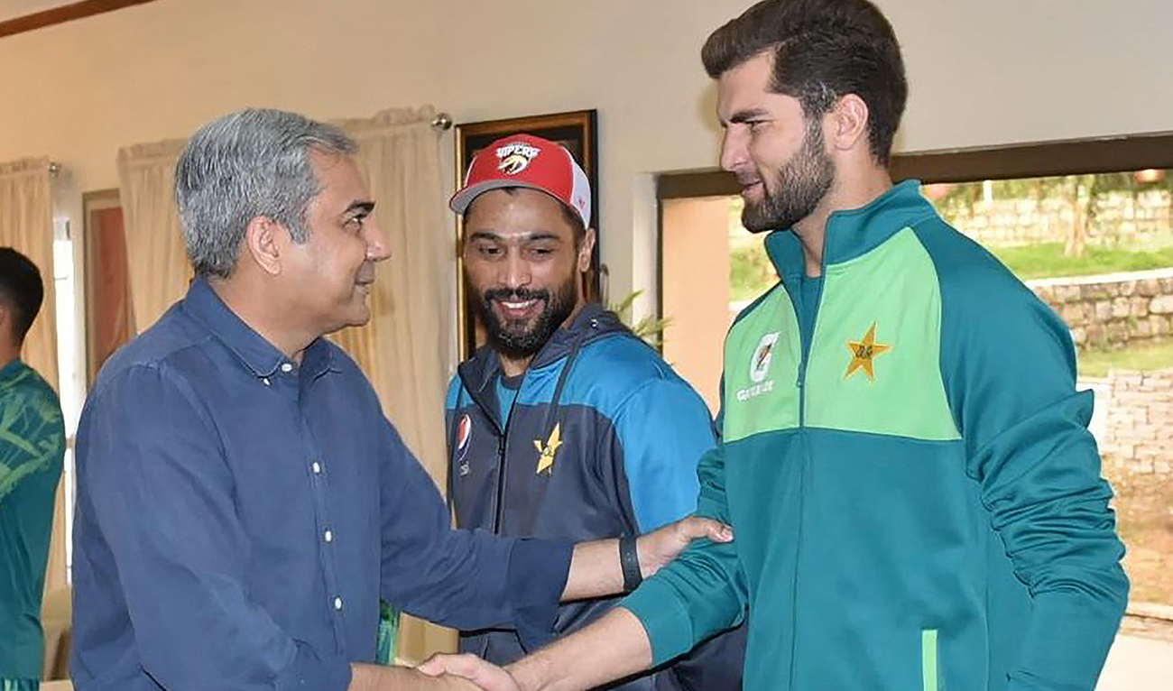 This handout photograph taken and released by Pakistan’s Cricket Board (PCB) on April 1, 2024, shows PCB Chairman Mohsin Naqvi (L) meets with cricketer Shaheen Shah Afridi (R) during his visit Pakistan team fitness camp being conducted by trainers from the Pakistan Army in Kakul, Abbottabad eastern Khyber Pakhtunkhwa province. (AFP)