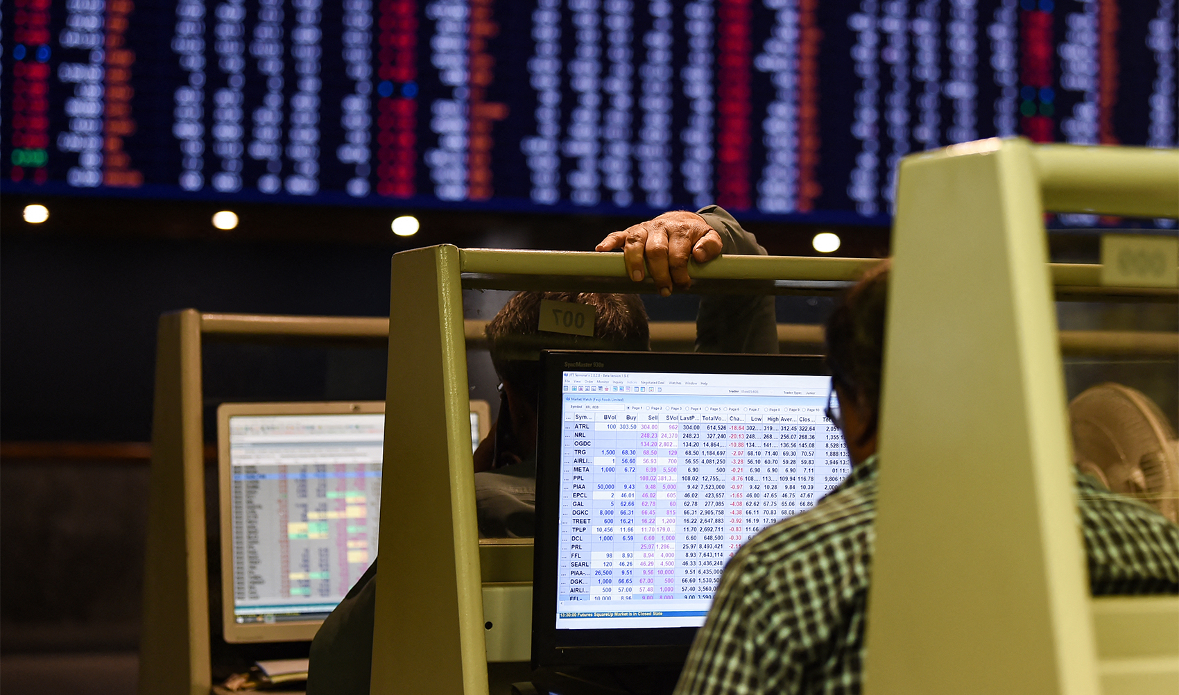 Stock brokers monitor share prices on computers during a trading session at the Pakistan Stock Exchange (PSX) in Karachi on February 12, 2024. (AFP/File)