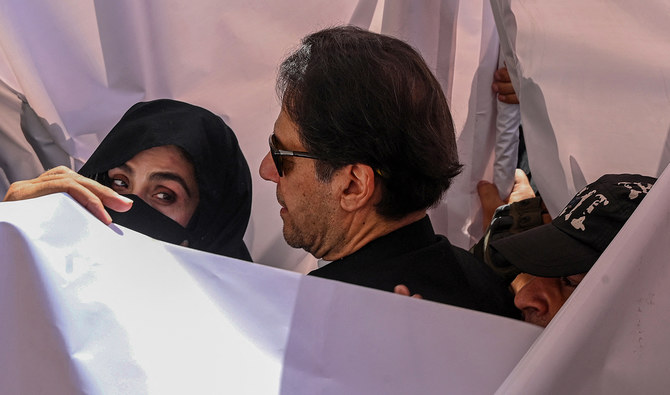 In this file photograph, taken on May 15, 2023, former Pakistan Prime Minister Imran Khan (C) with his wife Bushra Bibi (L) arrive to appear at a high court in Lahore. (AFP/File)