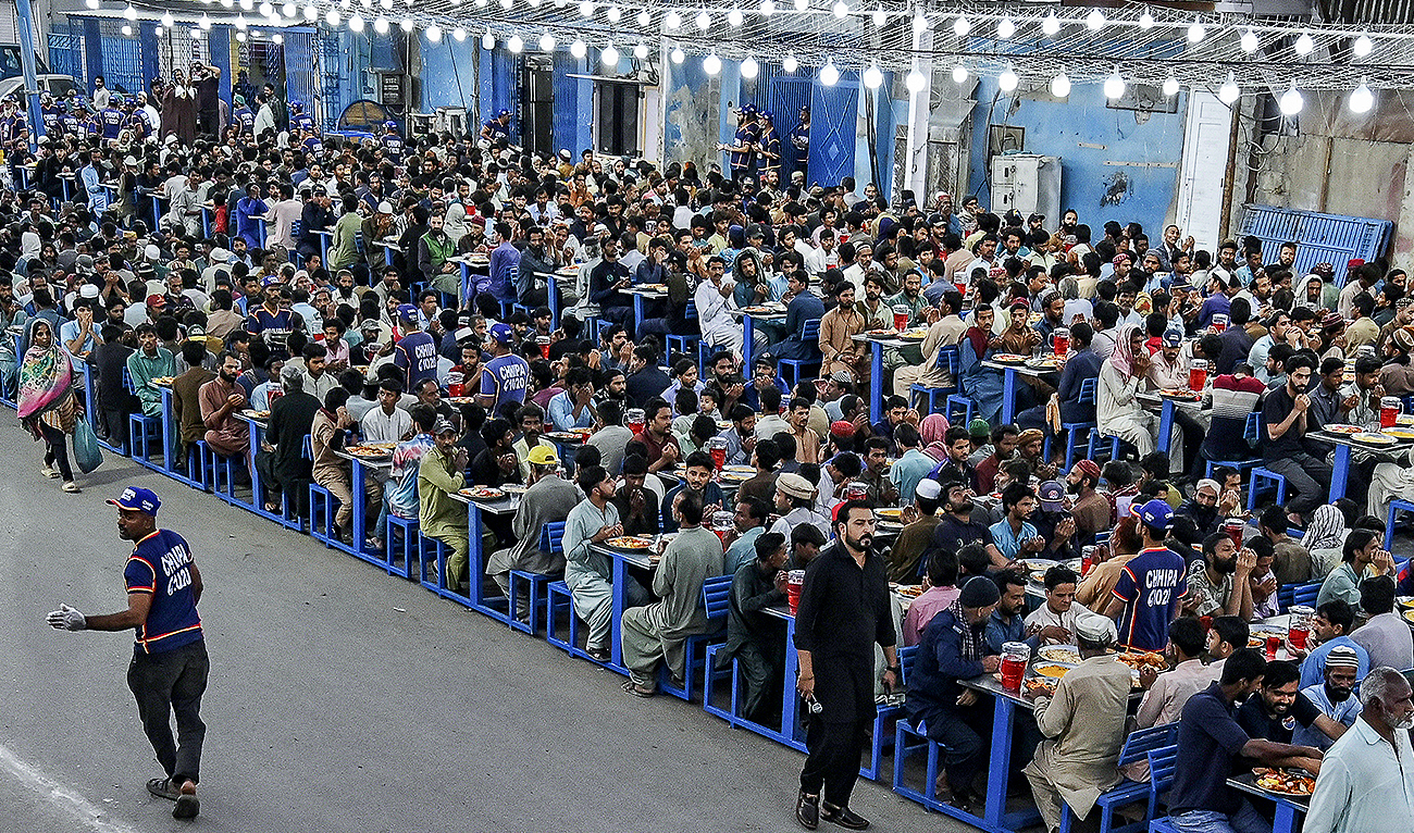Muslim devotees gather to break their fast during the Islamic holy month of Ramadan in Karachi on March 13, 2024. (AFP)