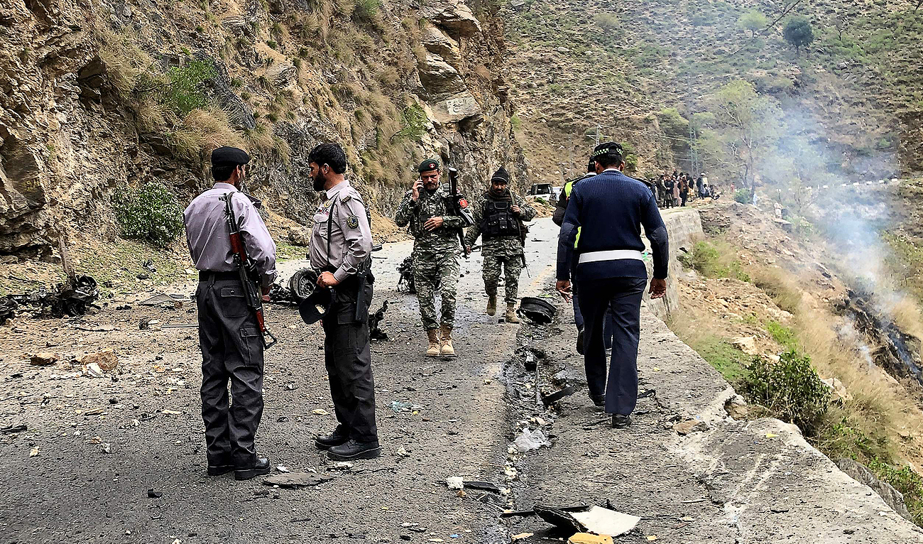 Security personnel inspect the site of a suicide attack near Besham city in the Shangla district of Khyber Pakhtunkhwa province on March 26, 2024. (AFP/File)