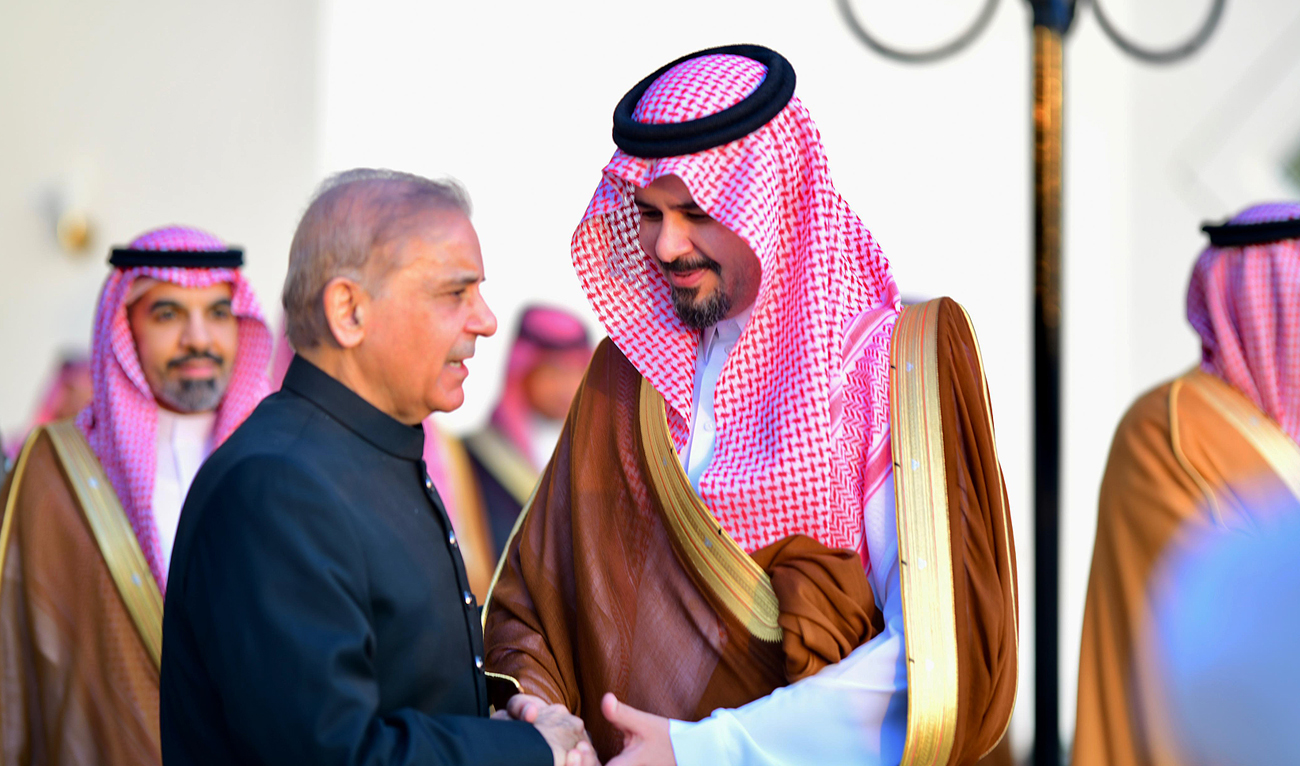 In this handout photograph, taken and released by Prime Minister’s Office, Pakistan Prime Minister Shehbaz Sharif shakes hands with Governor of Madinah Prince Salman bin Sultan Al Saud at the Prince Mohammad Bin Abdulaziz International Airport in Madinah on April 6, 2024. (Photo courtesy: PMO)