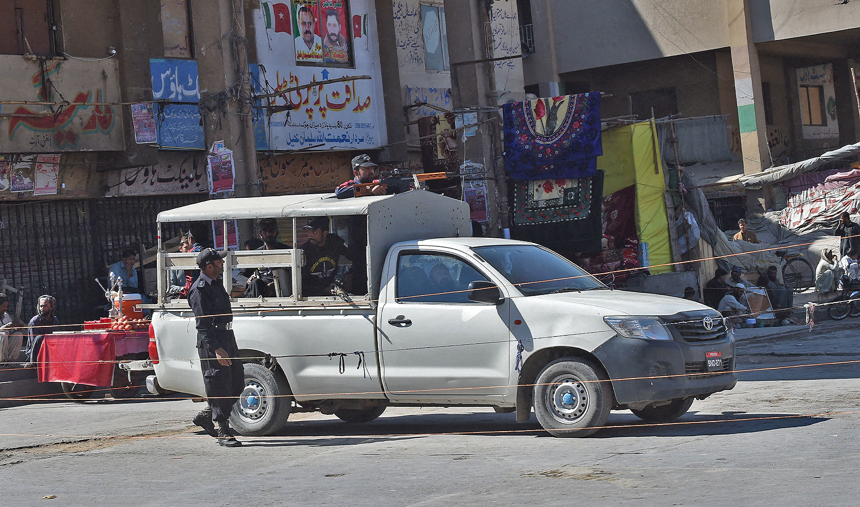 Pakistani policemen stand guard in front of shuttered shops at the market in Quetta, Pakistan, on October 26, 2016. (AFP/File)