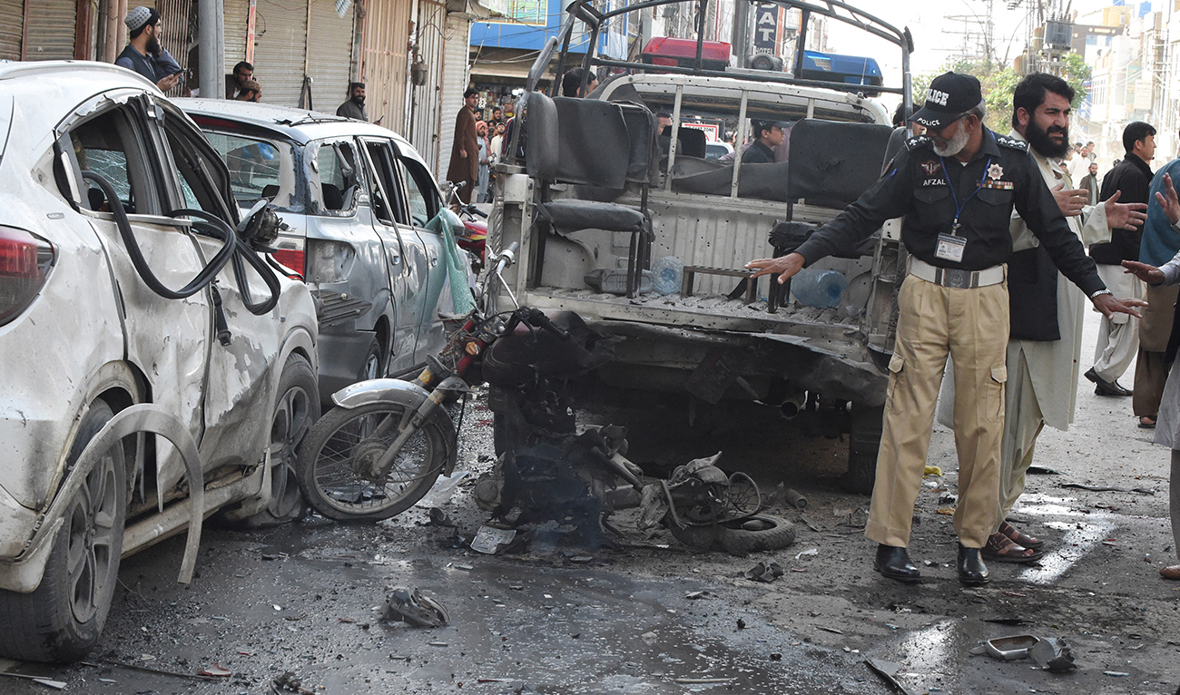 A police officer examines the site of a bomb blast in Quetta on April 10, 2023. (AFP/file)