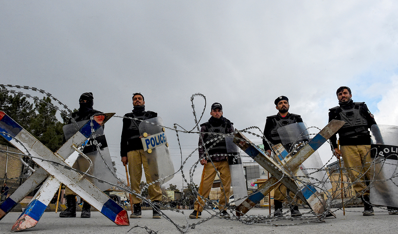 Police personnel set roadblocks as Pashtunknwa National Awami Party members protest in Quetta on February 28, 2024. (AFP/File)
