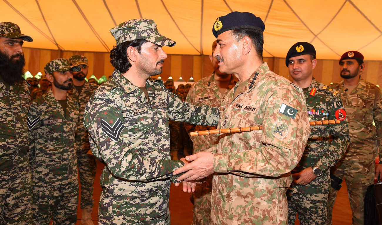 In this handout picture, taken and released by Inter Services Public Relations (ISPR) on April 11, 2024, Pakistan Army Chief General Syed Asim Munir (right) meets troops following Eid Al-Fitr prayers in North Waziristan. (Photo courtesy: ISPR)