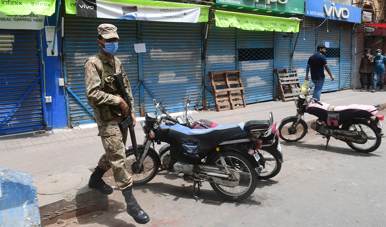 A soldier patrols along a commercial area after authorities closed a market area in Karachi, Pakistan on May 1, 2021. (AFP/File)