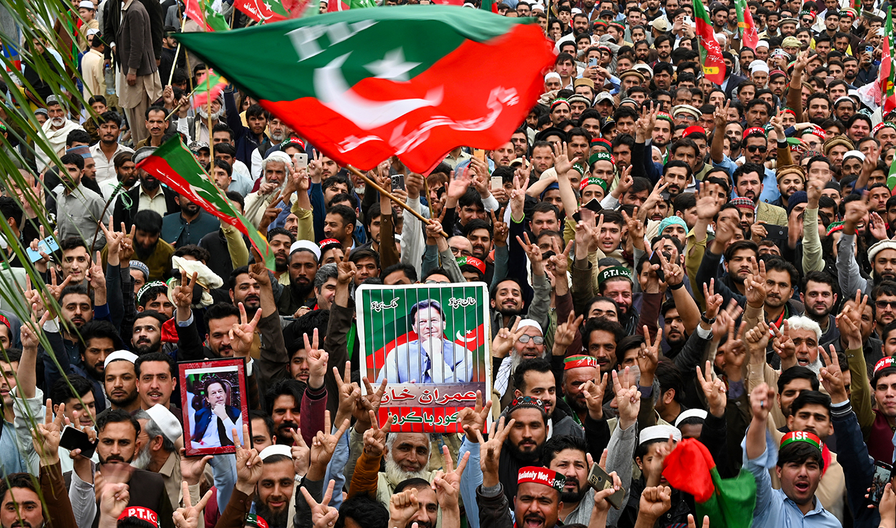 Pakistan Tehreek-e-Insaf (PTI) party supporters hold portraits of Pakistan's former prime minister Imran Khan, as they protest against the alleged skewing in Pakistan's national election, in Peshawar on March 10, 2024. (AFP/File)