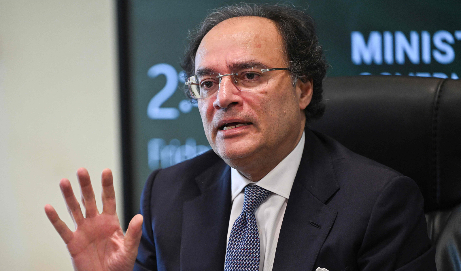 Pakistan Finance Minister Muhammad Aurangzeb gestures while speaking with media representatives at the finance ministry in Islamabad on March 22, 2024. (AFP/File)