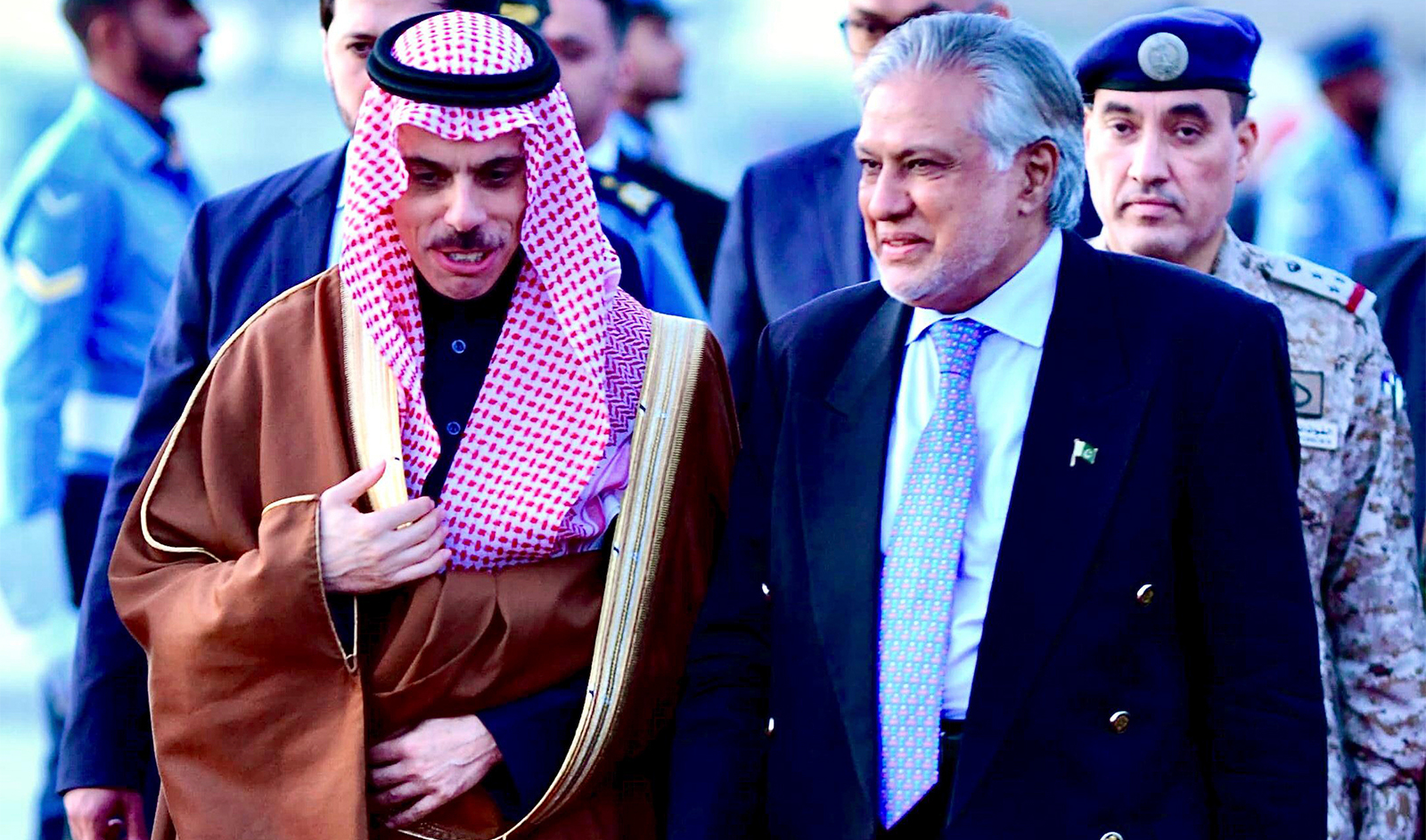 In this photo released by Ministry of Foreign Affairs, Pakistani's Foreign Minister Ishaq Dar, right, greets his Saudi counterpart Prince Faisal bin Farhan upon his arrival at a military airbase in Rawalpindi, Pakistan on April 15, 2024. (Ministry of Foreign Affairs via AP)