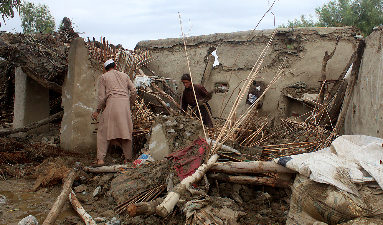 People remove debris of a damaged house following a flash flood in Gulgad village in Lal Pur district of Nangarhar province, Afghanistan, April 15, 2024. (REUTERS)