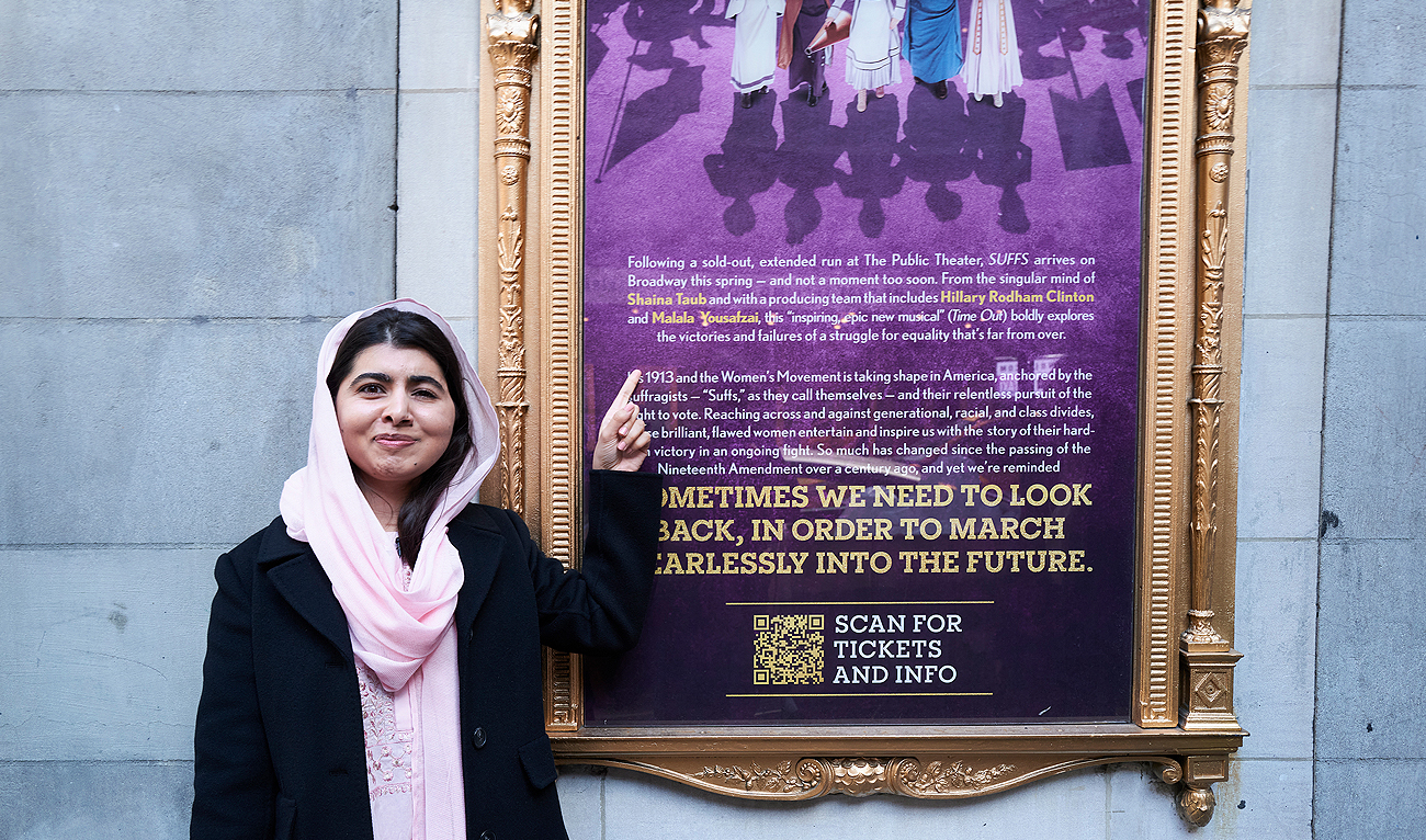 This photo provided by Rubenstein shows Malala Yousafzai pointing to a sign for her off-Broadway musical in New York. (AP)
