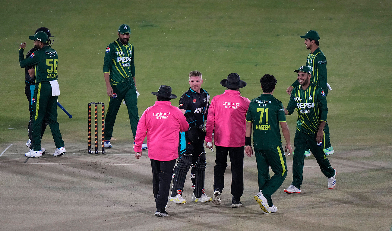 New Zealand’s Tim Seifert, center, shakes hand with umpires after the first T20 cricket match between Pakistan and New Zealand call-off due to rain, in Rawalpindi on April 18, 2024. (AP)