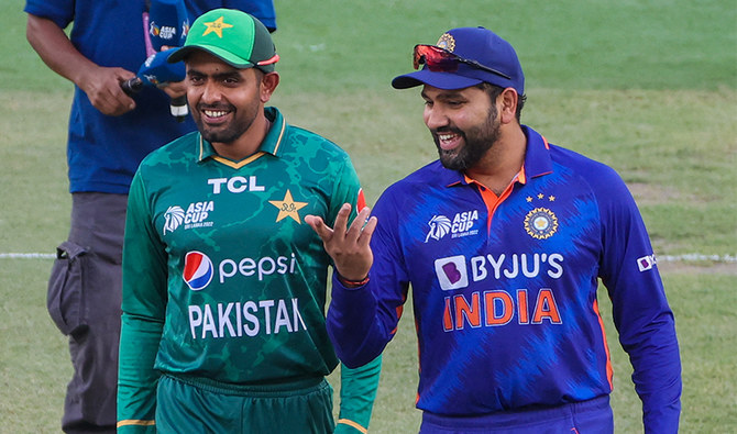 India's captain Rohit Sharma (R) and Pakistan's captain Babar Azam arrive for the toss before start of the Asia Cup Twenty20 international cricket Group A match at the Dubai International Cricket Stadium on August 28, 2022. (AFP/File)